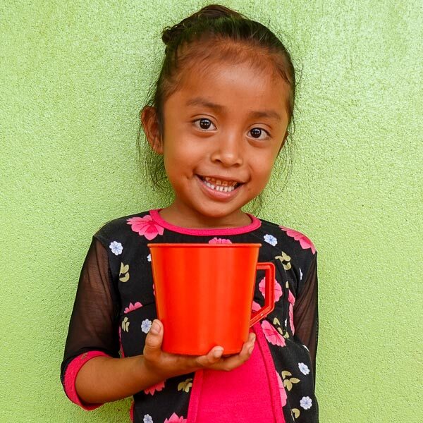 Guatemalan student receiving nutrient-enriched school snack